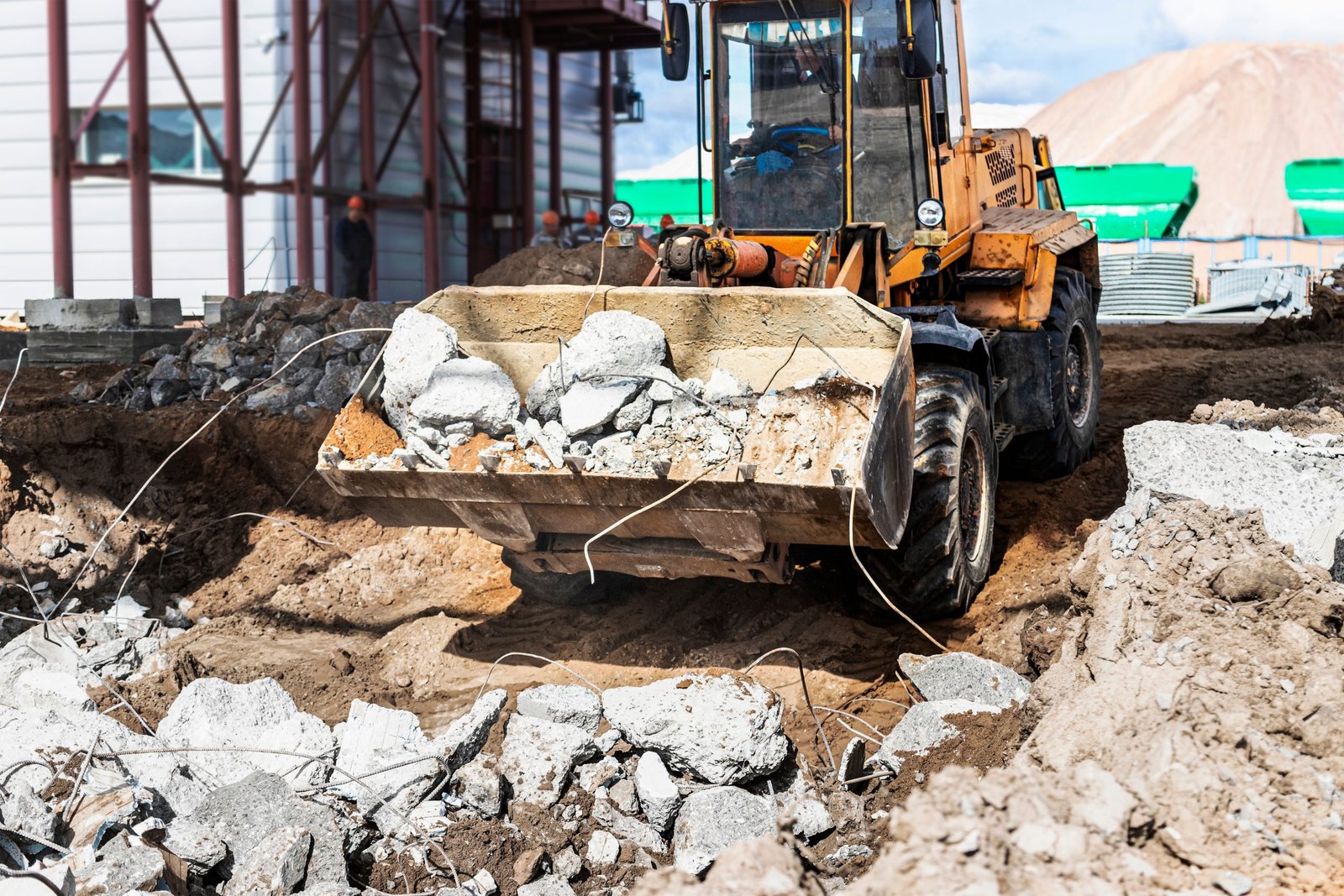 A,Front-end,Loader,At,A,Construction,Site,Removes,Debris,From